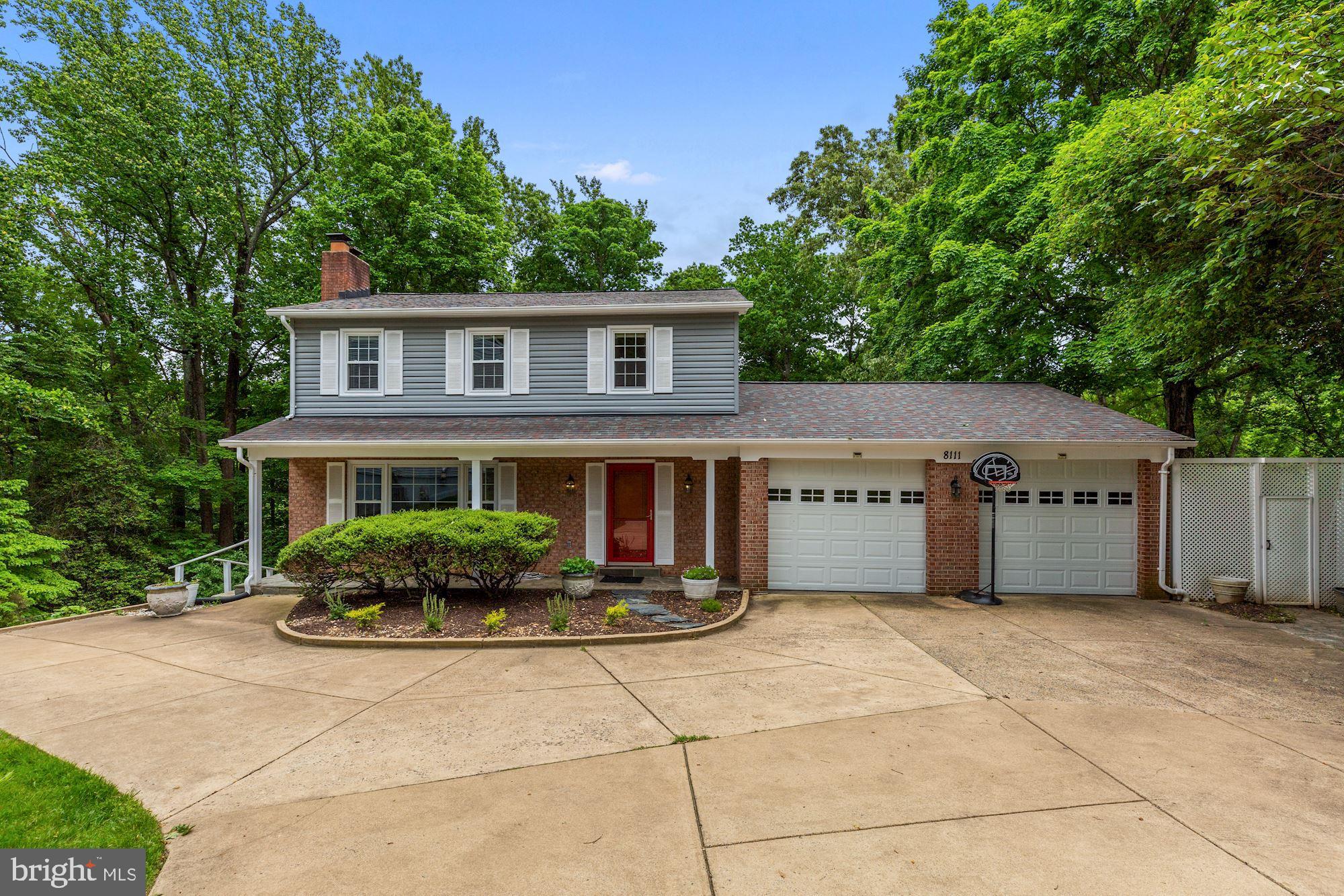 8111 West Point Drive Springfield, VA 22153 - Photo 1 of 46 a front view of a house with a garden