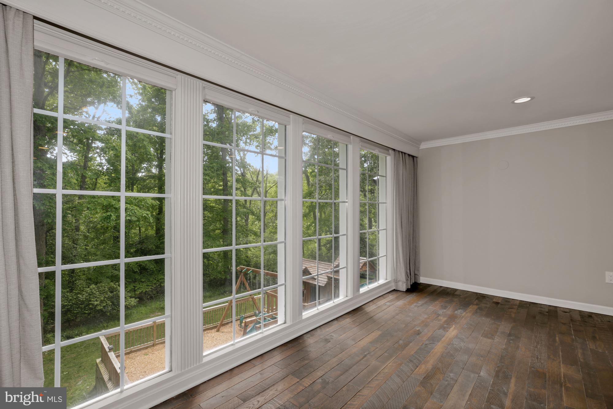 8111 West Point Drive Springfield, VA 22153 - Photo 13 of 46 a view of an empty room with wooden floor and windows