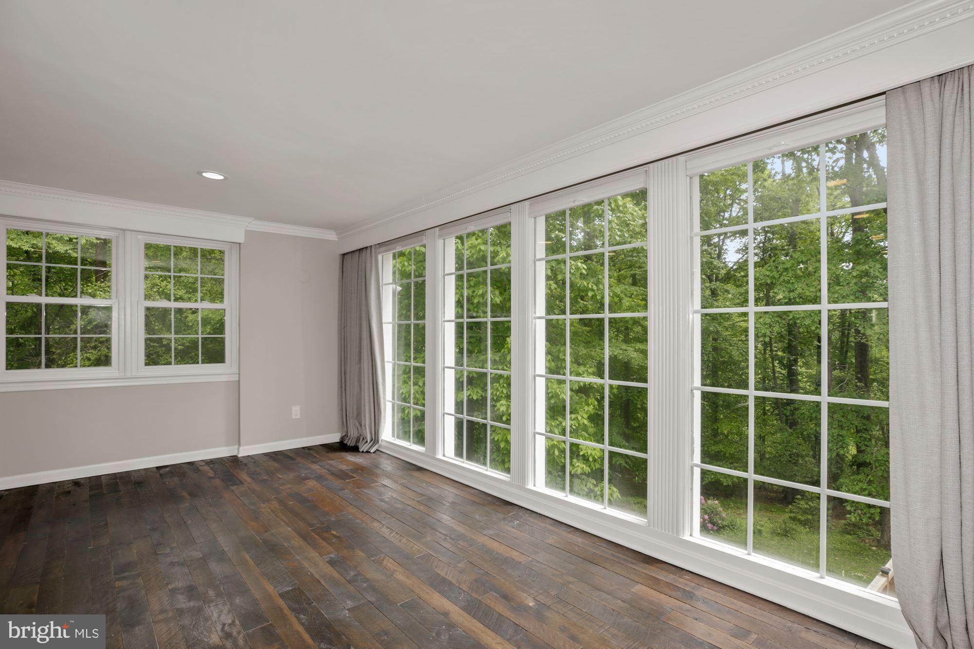 8111 West Point Drive Springfield, VA 22153 - Photo 14 of 46 a view of empty room with wooden floor and windows