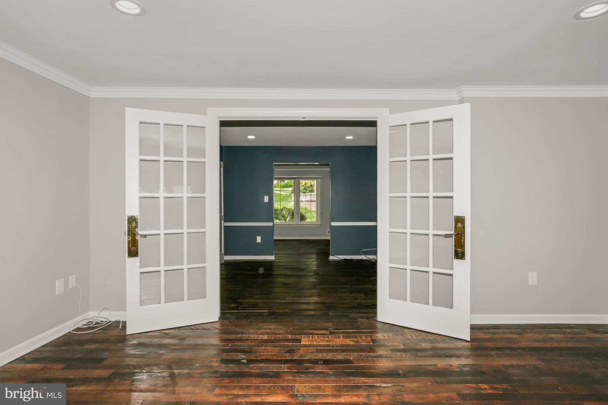 8111 West Point Drive Springfield, VA 22153 - Photo 17 of 46 a view of empty room with wooden floor and kitchen view
