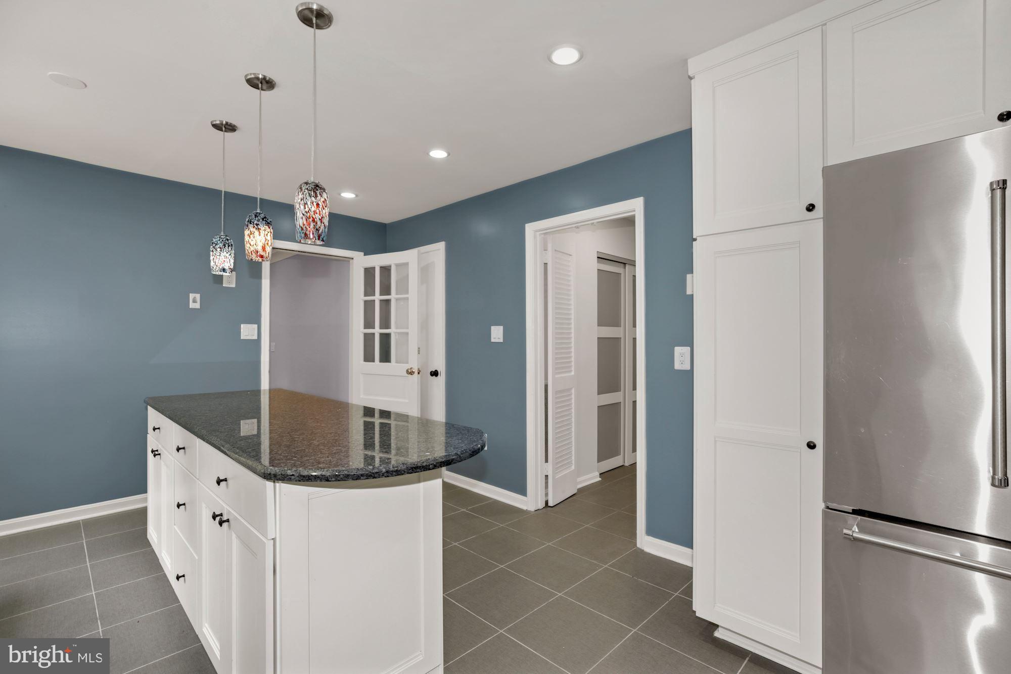 8111 West Point Drive Springfield, VA 22153 - Photo 18 of 46 a kitchen with granite countertop a refrigerator and a sink