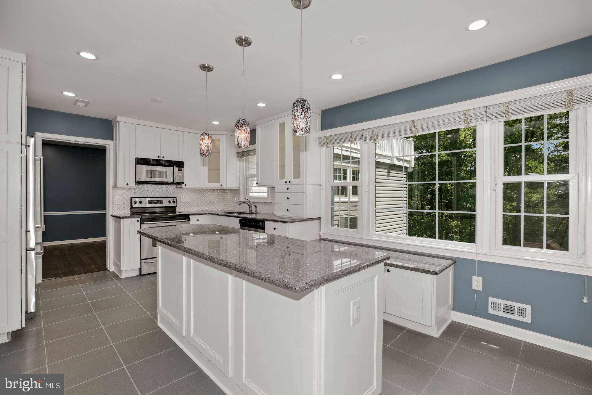 8111 West Point Drive Springfield, VA 22153 - Photo 20 of 46 a kitchen with stainless steel appliances granite countertop a sink and a stove