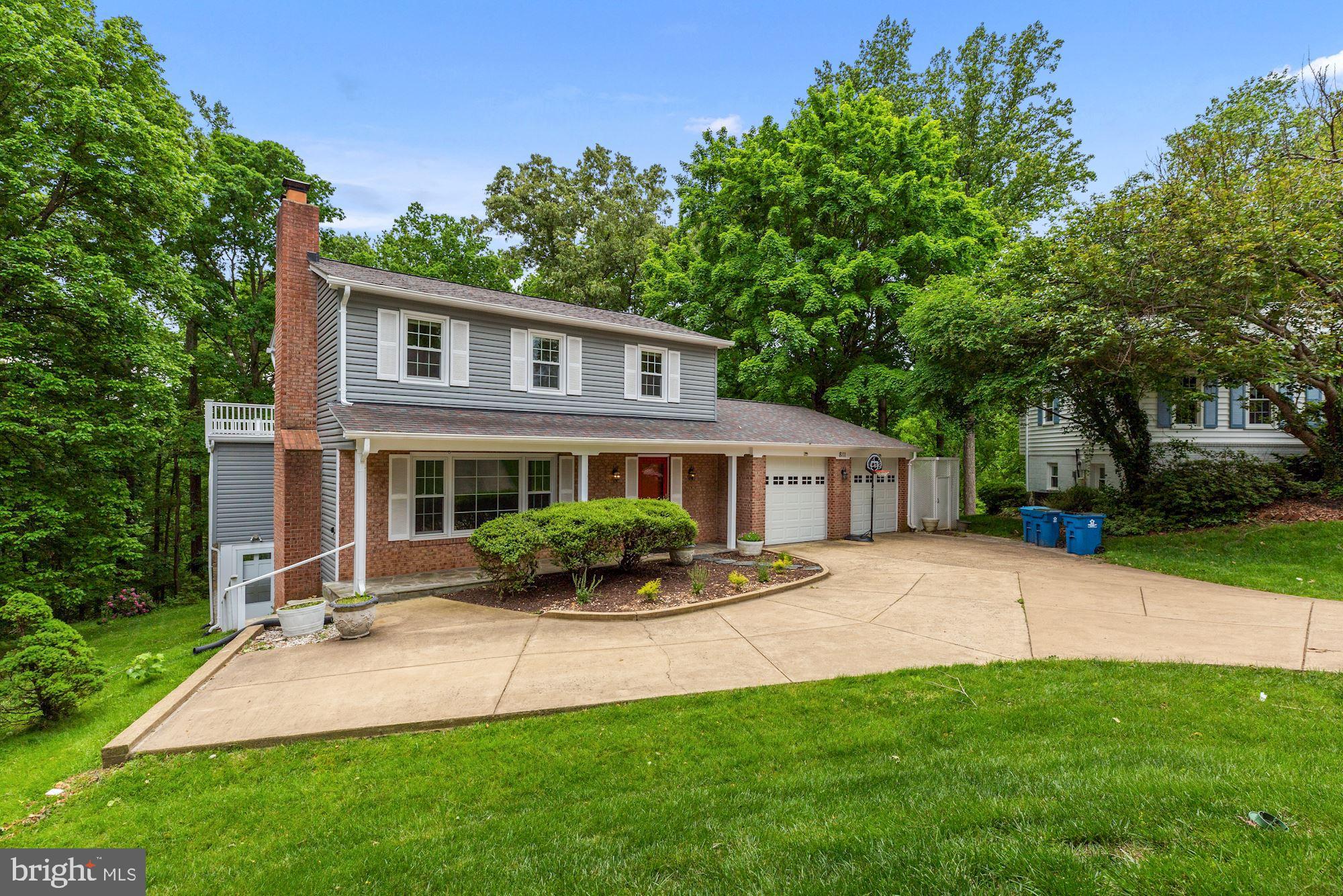 8111 West Point Drive Springfield, VA 22153 - Photo 2 of 46 a front view of a house with a yard