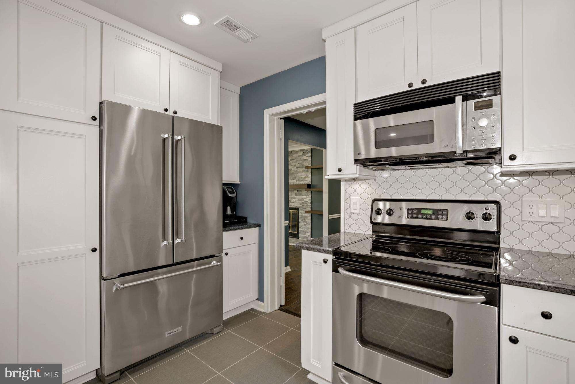 8111 West Point Drive Springfield, VA 22153 - Photo 21 of 46 a kitchen with cabinets and stainless steel appliances