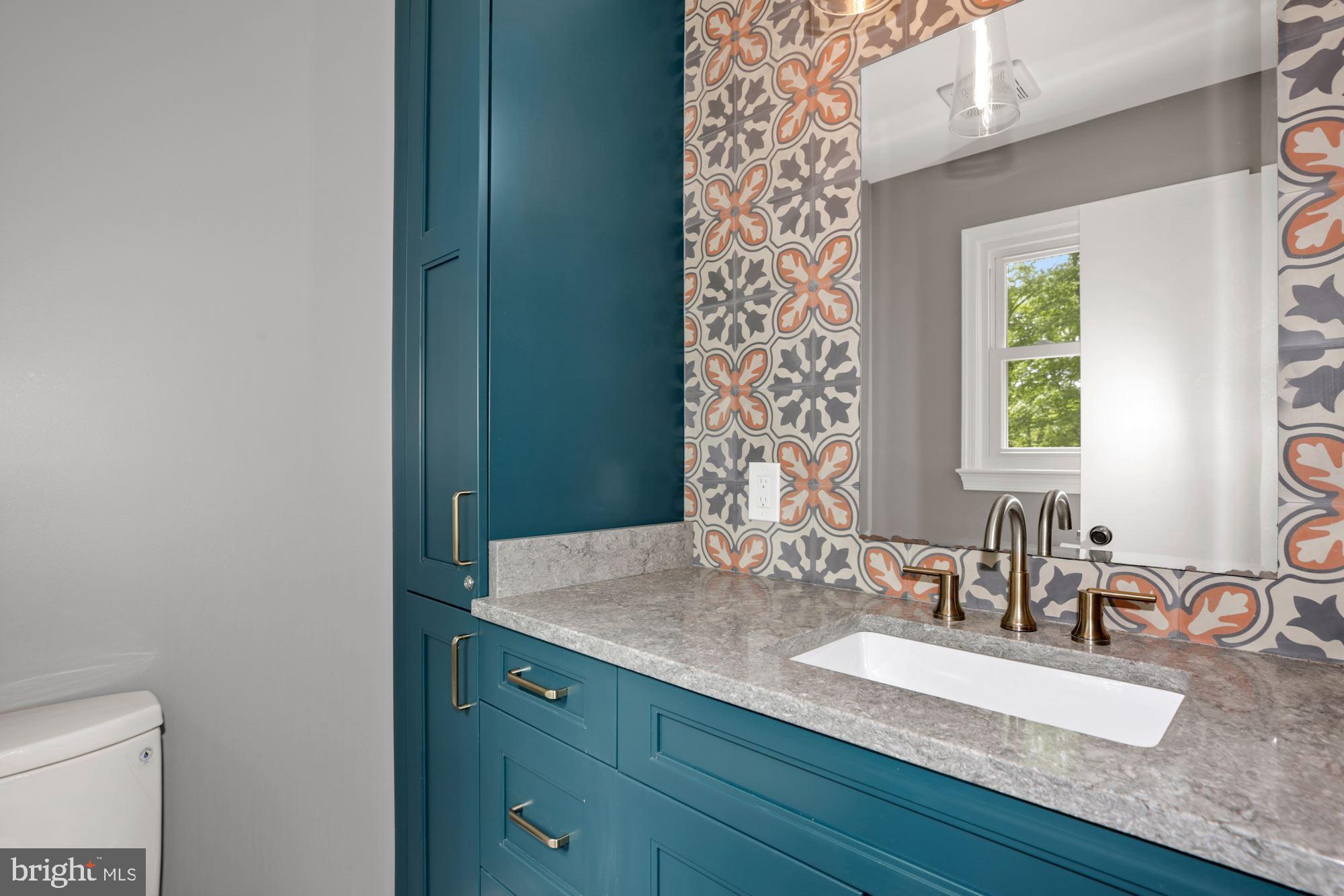 8111 West Point Drive Springfield, VA 22153 - Photo 22 of 46 a bathroom with a granite countertop sink a mirror and a toilet
