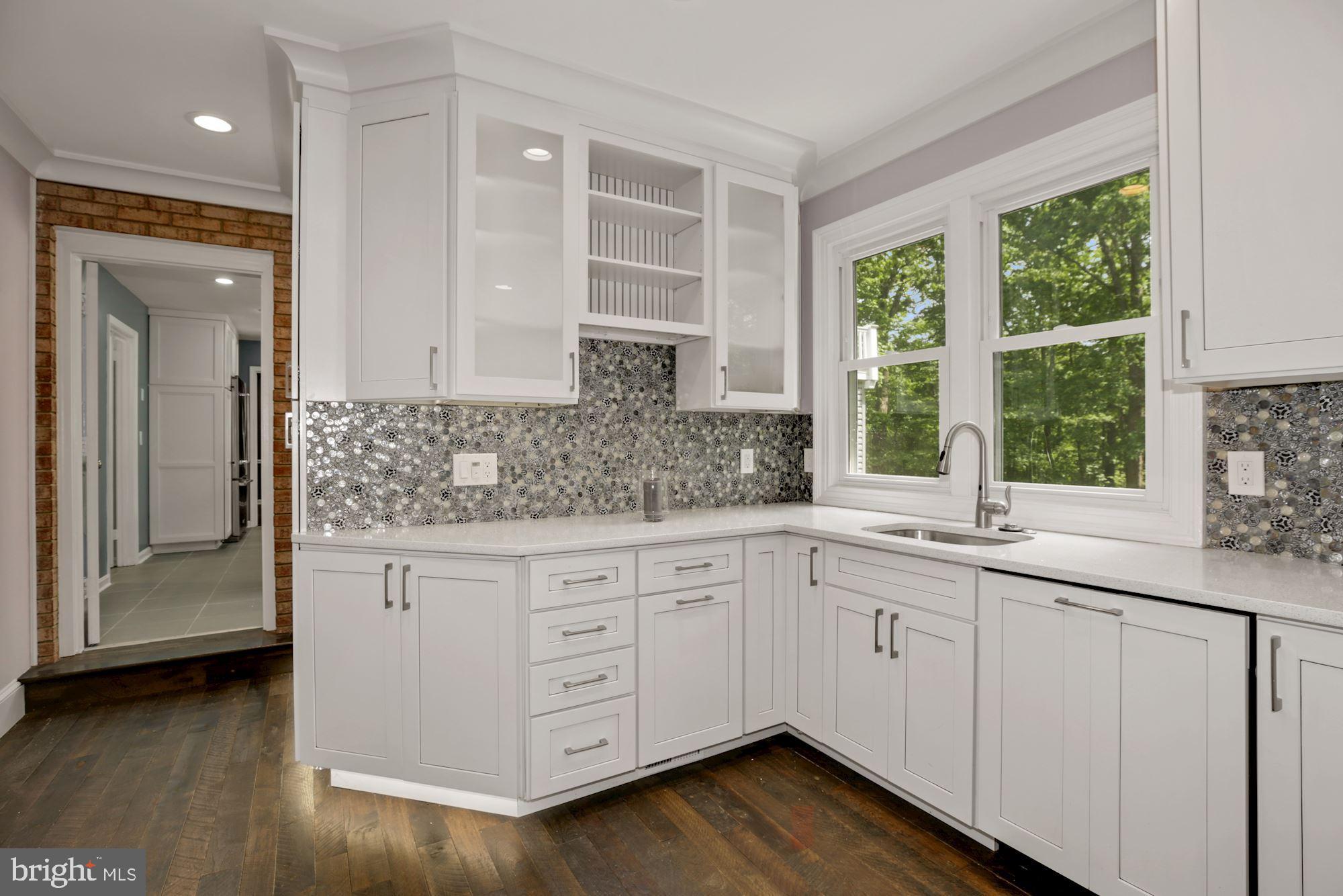 8111 West Point Drive Springfield, VA 22153 - Photo 23 of 46 a kitchen with granite countertop white cabinets and a sink