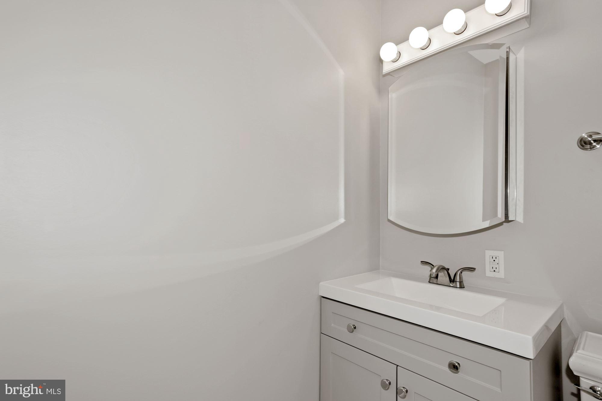 8111 West Point Drive Springfield, VA 22153 - Photo 27 of 46 a bathroom with a sink vanity and a mirror