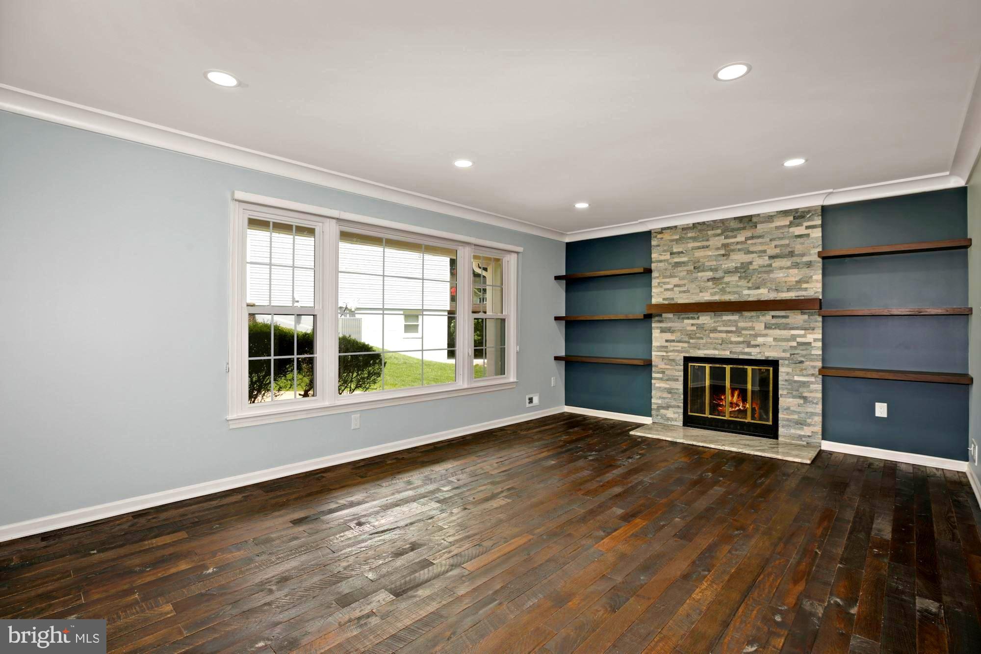 8111 West Point Drive Springfield, VA 22153 - Photo 4 of 46 an empty room with windows and fireplace