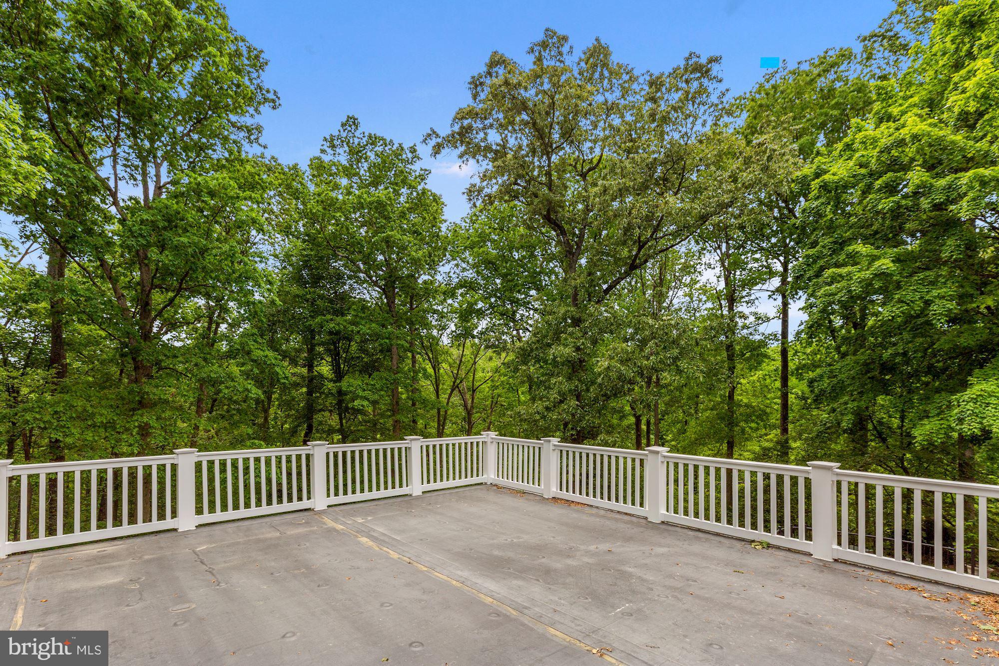 8111 West Point Drive Springfield, VA 22153 - Photo 43 of 46 a view of a roof deck with wooden fence and floor