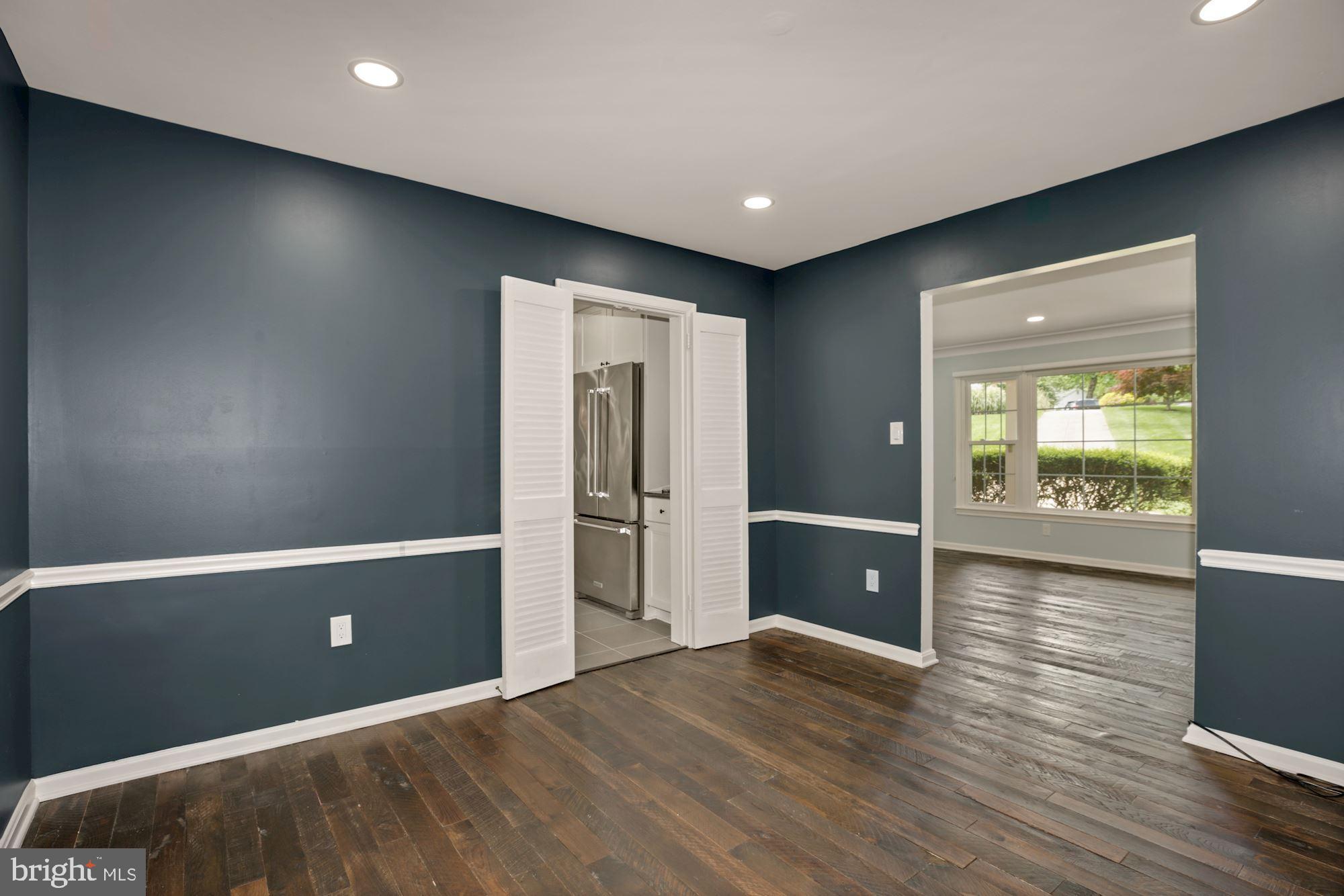 8111 West Point Drive Springfield, VA 22153 - Photo 8 of 46 an empty room with wooden floor and windows