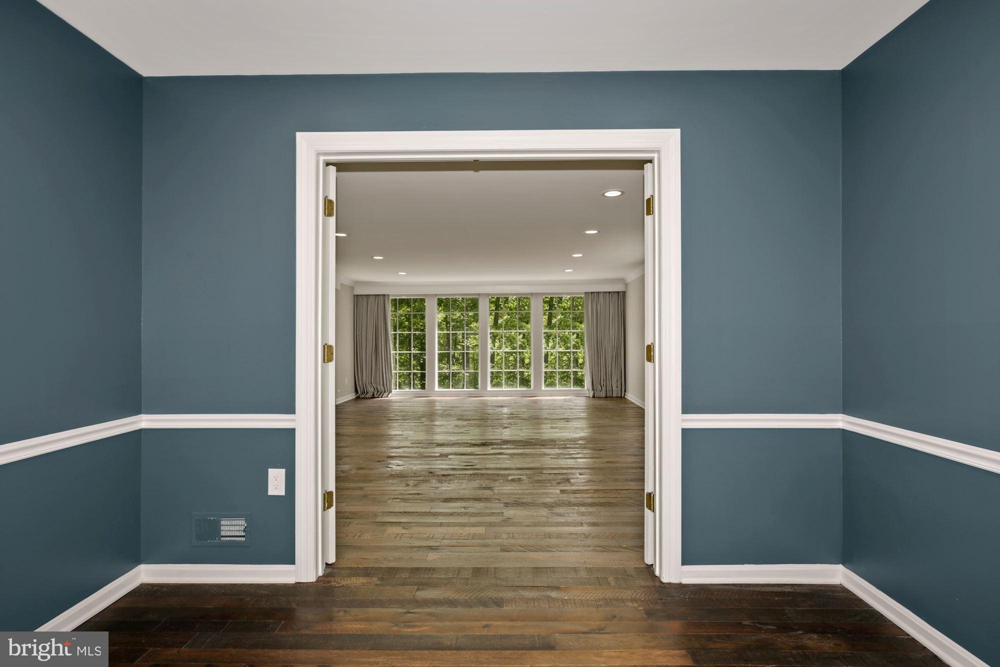 8111 West Point Drive Springfield, VA 22153 - Photo 9 of 46 a view of an empty room with wooden floor and a window