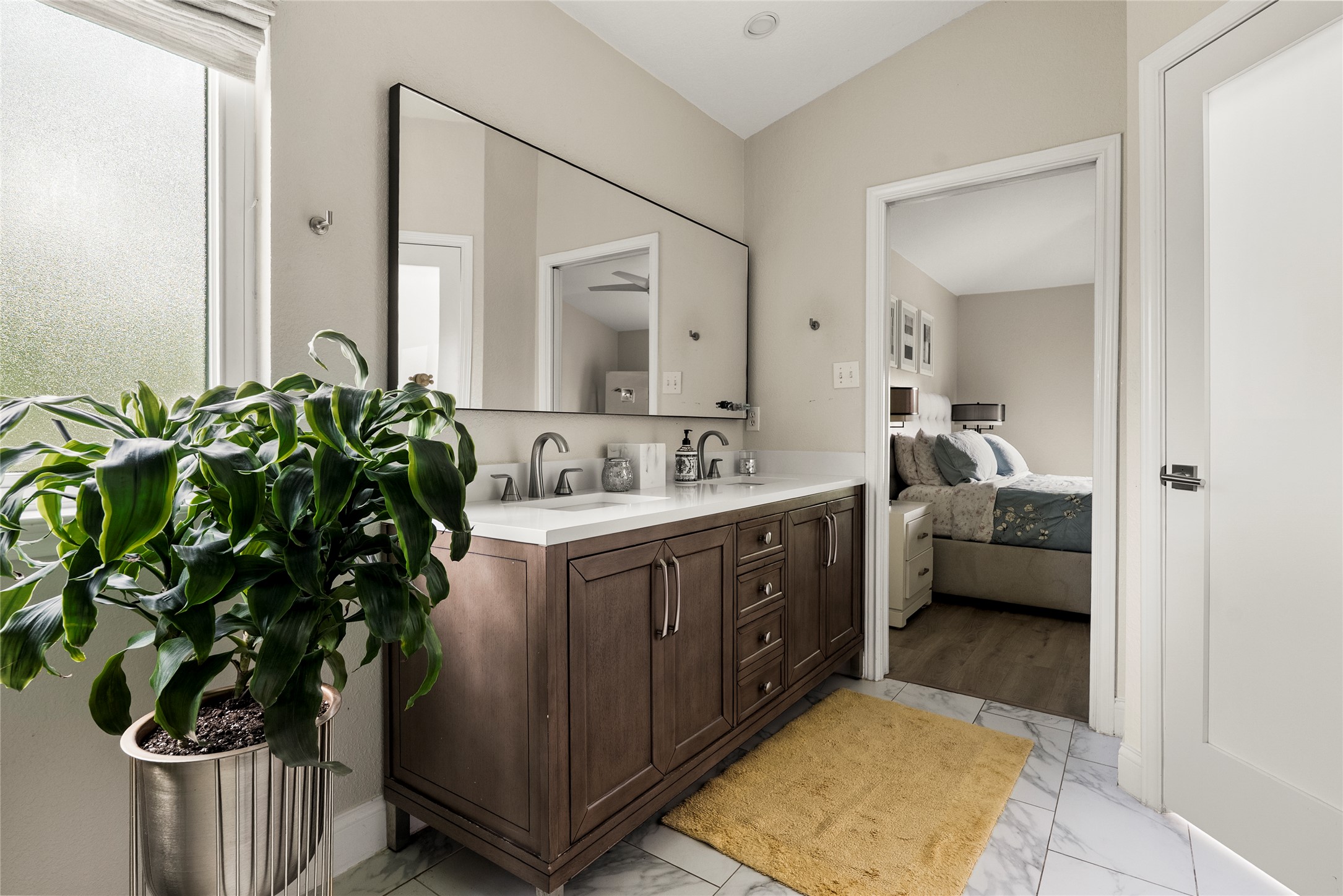 7021 Colberg Court Austin, TX 78749 - Photo 25 of 37 a en suite bathroom with a sink and a mirror
