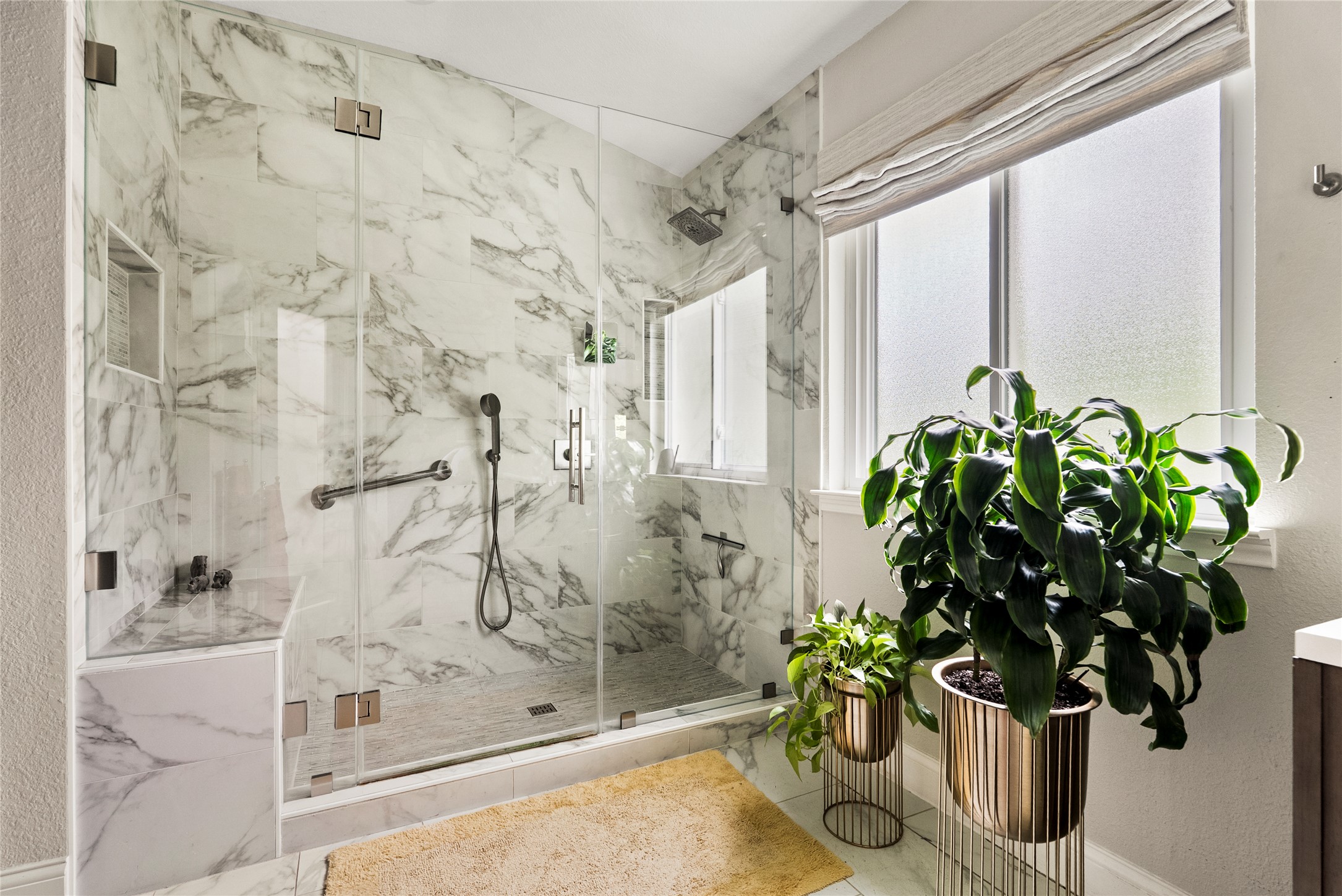 7021 Colberg Court Austin, TX 78749 - Photo 26 of 37 a view of a glass shower door with a potted plant