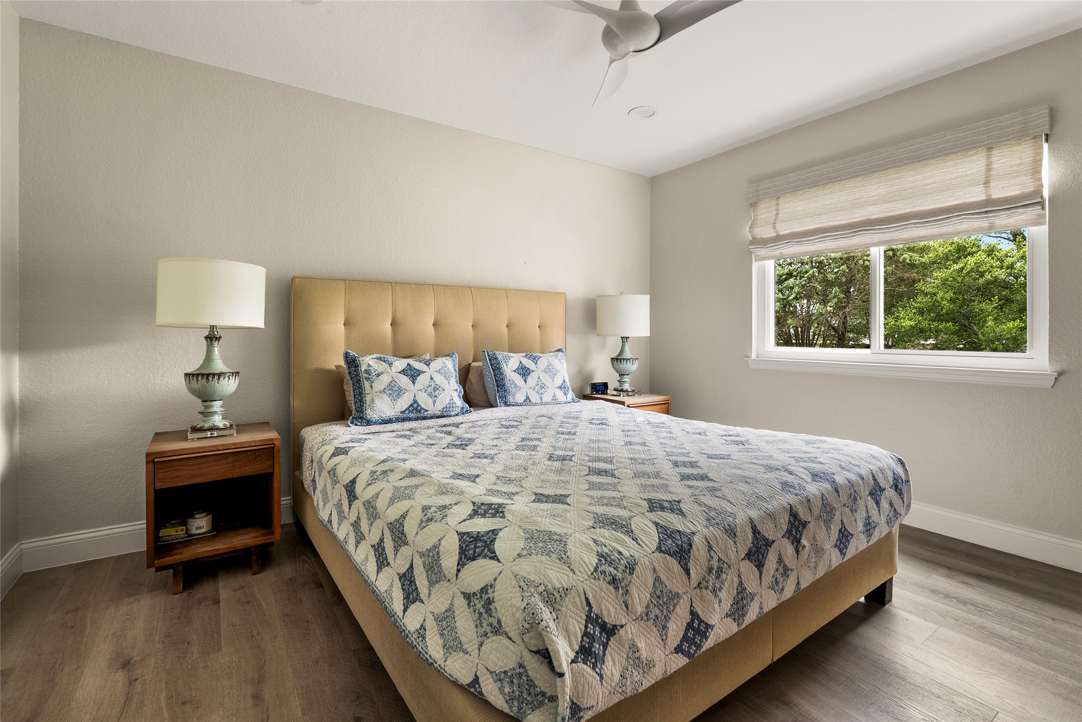 7021 Colberg Court Austin, TX 78749 - Photo 29 of 37 a large bed sitting in a bedroom next to a window and a lamp