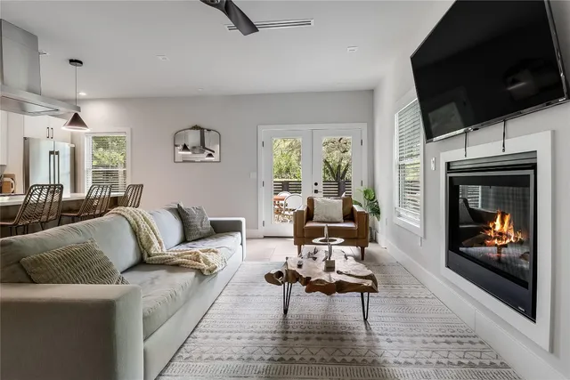 a living room with furniture a flat screen tv and a fireplace