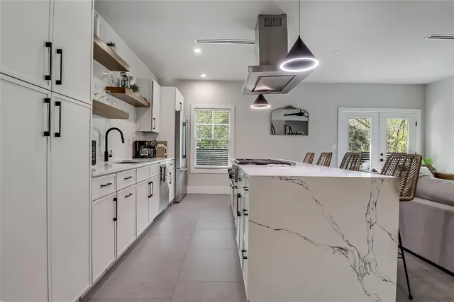 a bedroom with a large bed and a wooden floor