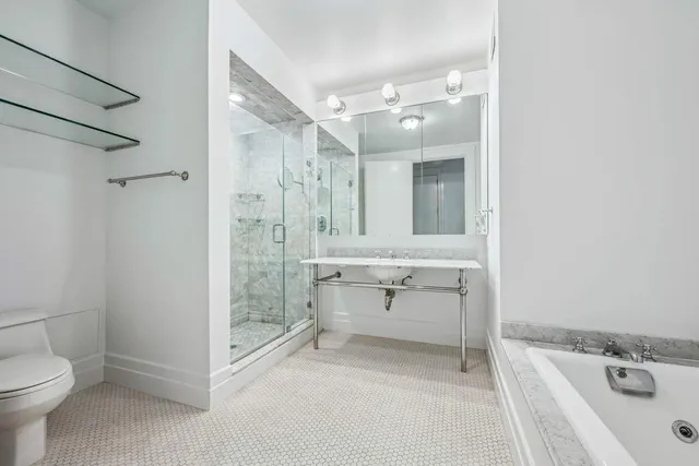 a bathroom with a sink a toilet and shower