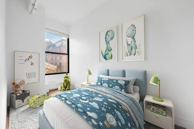 a bedroom with a bed a painting on the wall and a window