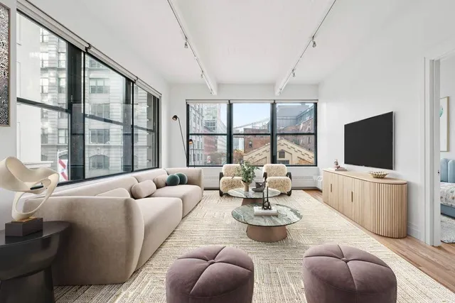 a living room with furniture flat screen tv and a large window