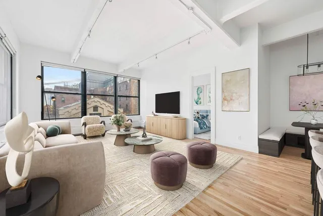 a living room with furniture wooden floor and window