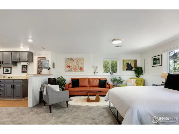 a bedroom with a large bed and a couch