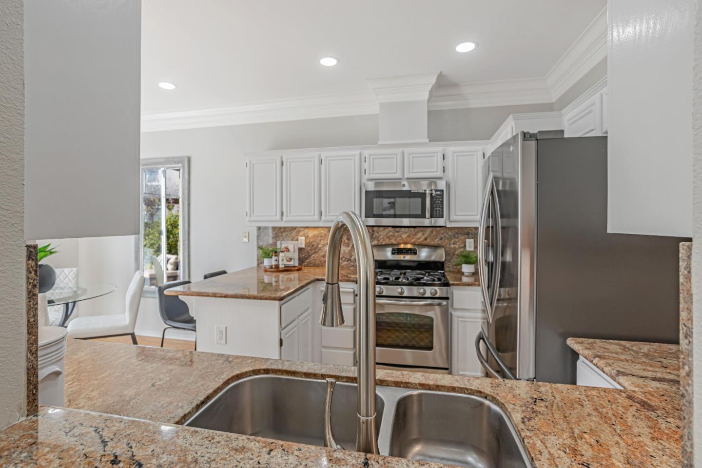 298 Gemstone Way Milpitas, CA 95035 - Photo 15 of 41 a kitchen that has a sink cabinets and stainless steel appliances