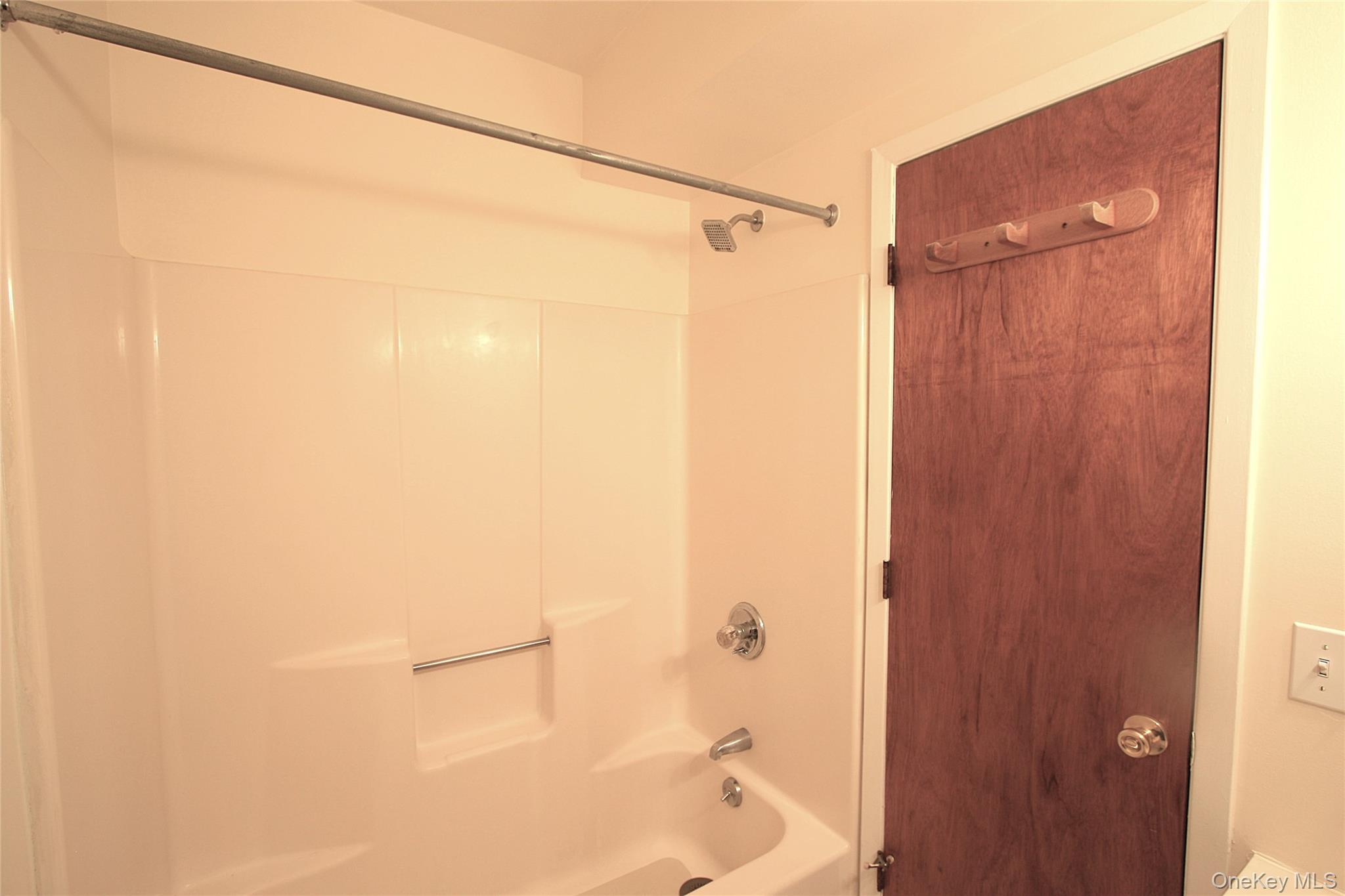 3115 Albany Post Road, Unit 2 Buchanan, NY 10511 - Photo 9 of 15 The bathroom has a tub and shower, with an easy to clean surround and great shower head.