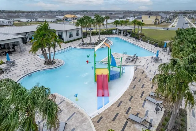 an aerial view of a house with swimming pool garden and patio