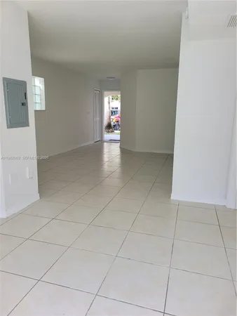 a view of a livingroom with an empty space and a window