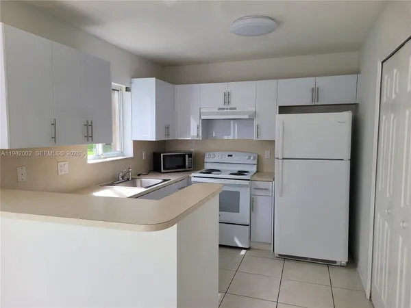 a kitchen with stainless steel appliances a refrigerator stove microwave and sink