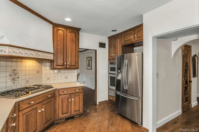 a kitchen with stainless steel appliances granite countertop a refrigerator and a stove