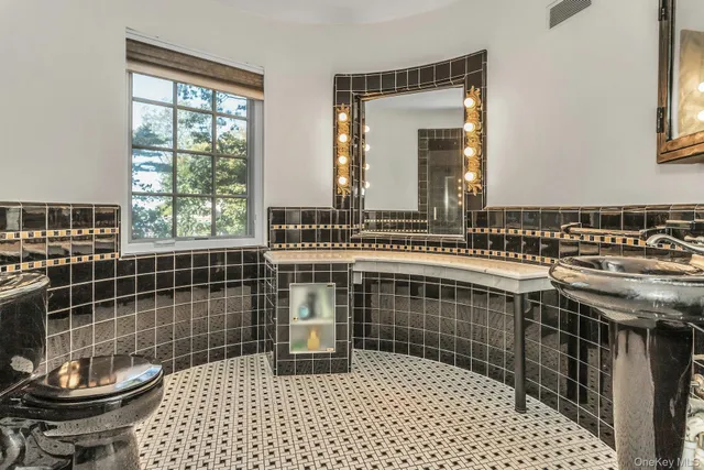 a bathroom with a sink a toilet and a shower