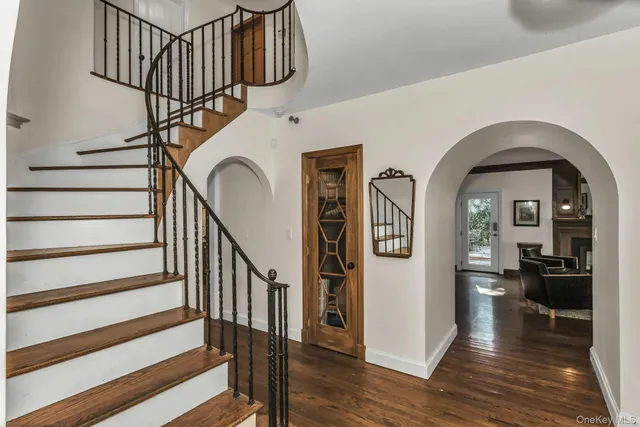 a view of staircase with wooden floor and a rug