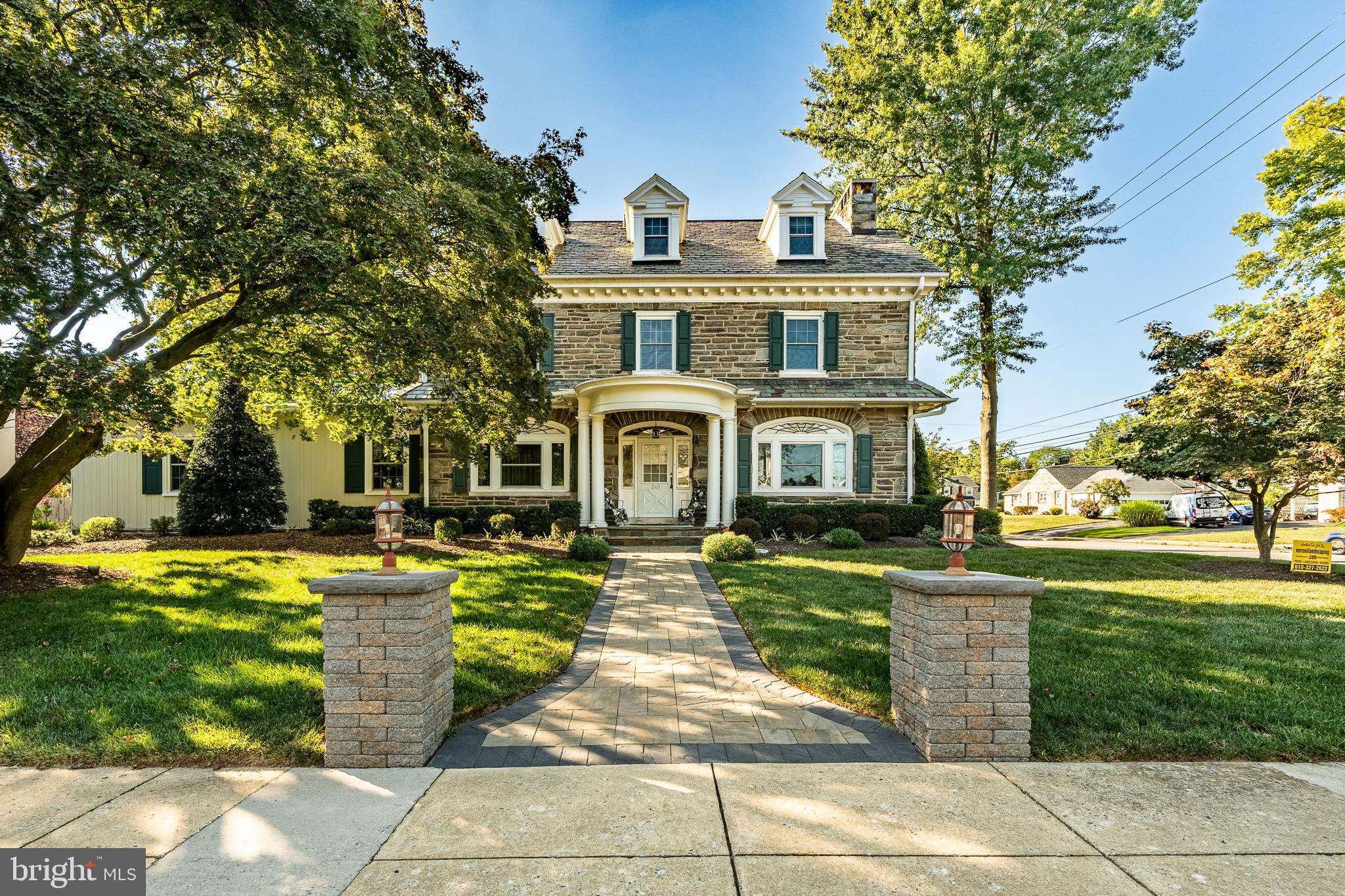 a front view of a brick house with a yard
