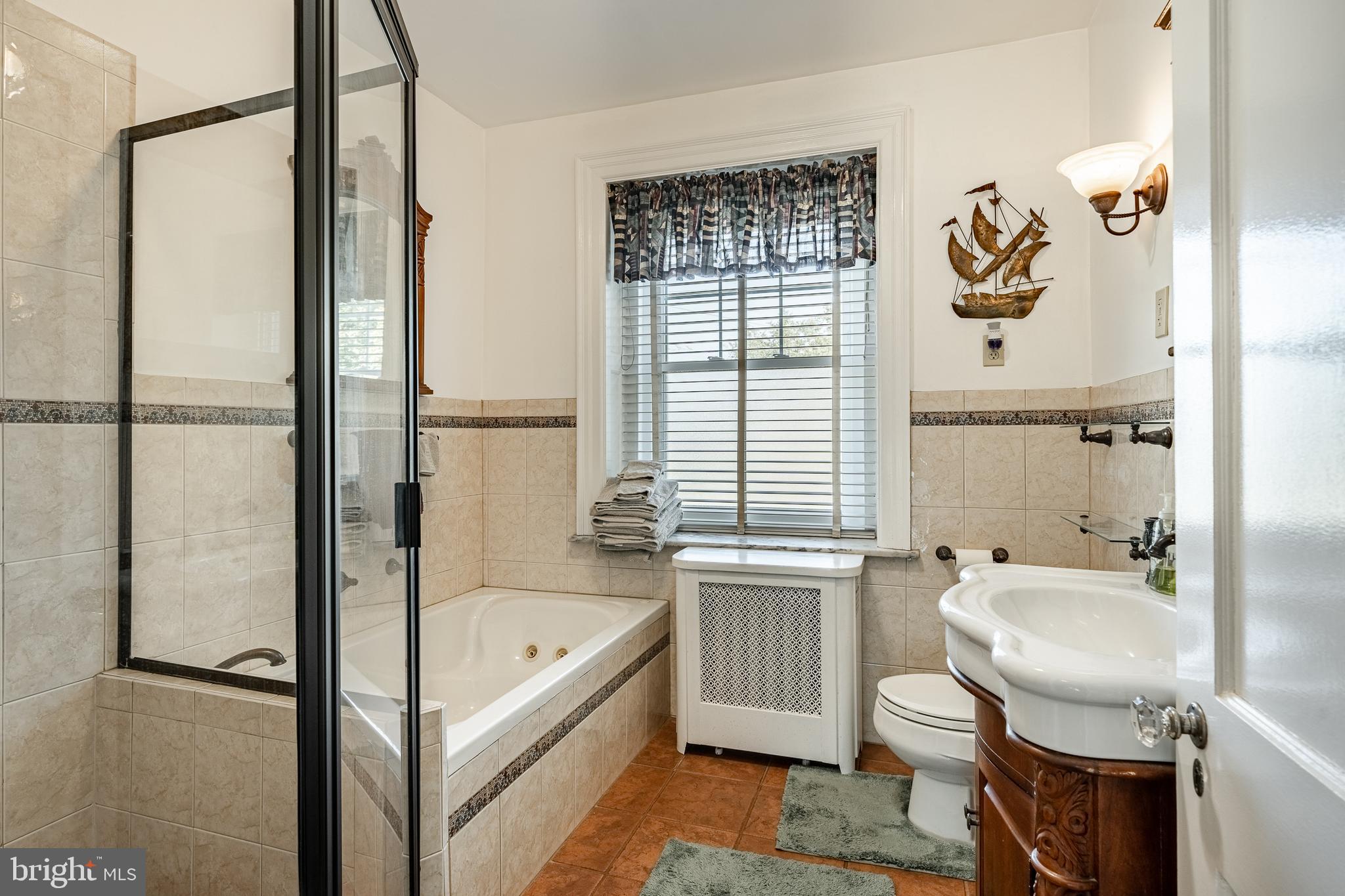 245 Rosedale Drive Pottstown, PA 19464 - Photo 41 of 57 a bathroom with a tub sink toilet and a mirror