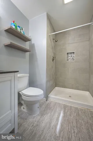 a bathroom with a toilet and shower