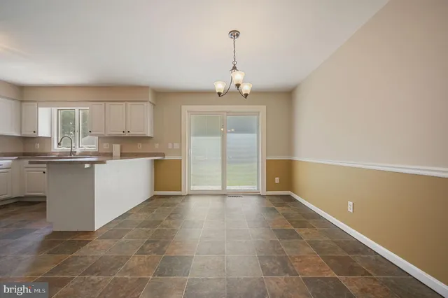 a view of a kitchen with a sink and a window