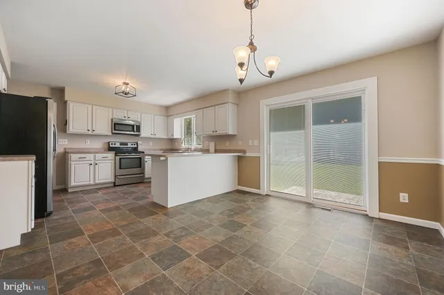a large kitchen with cabinets and stainless steel appliances