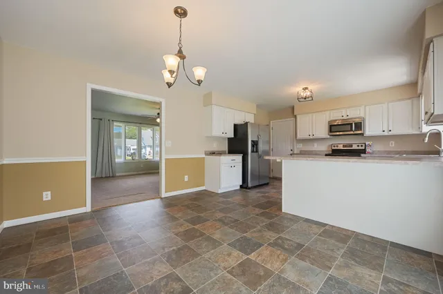 a view of a kitchen with microwave and cabinets