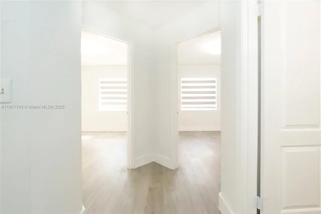 a view of an empty room and a window