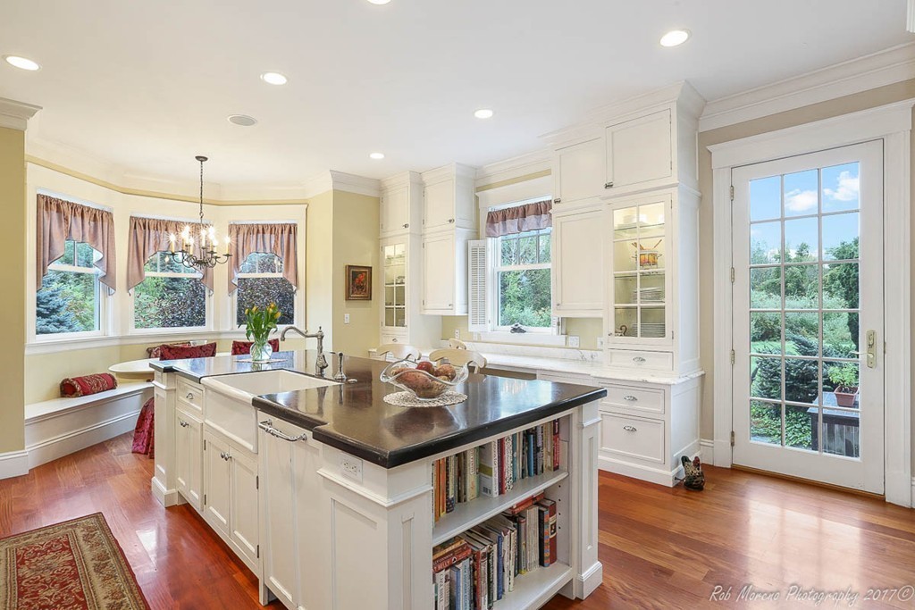 10 Hovey's Pond Boxford, MA 01921 - Photo 10 of 30 a kitchen with a stove a sink dishwasher and a dining table with wooden floor