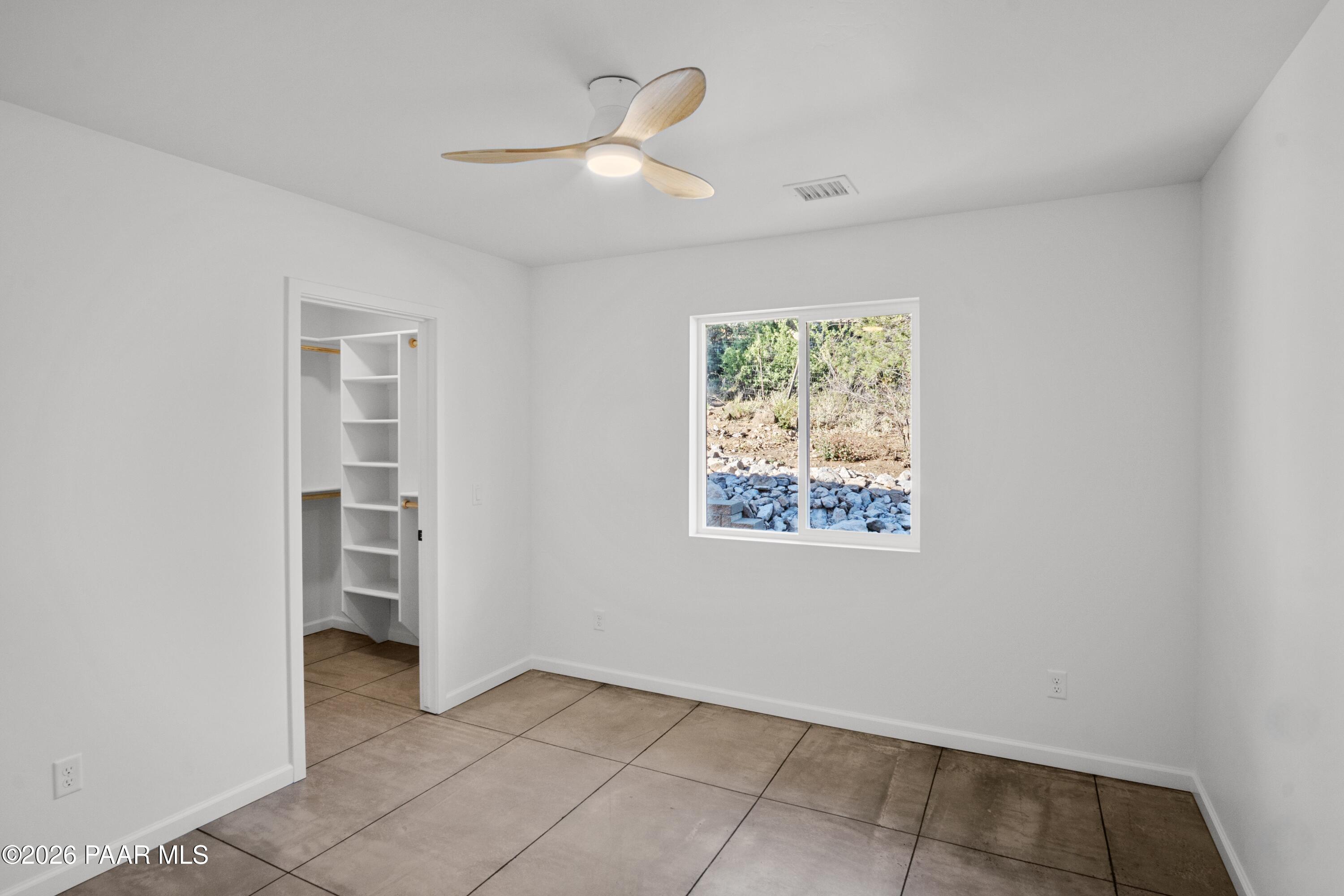 4920 East Amber Road Prescott, AZ 86301 - Photo 30 of 38 an empty room with a window and a ceiling fan