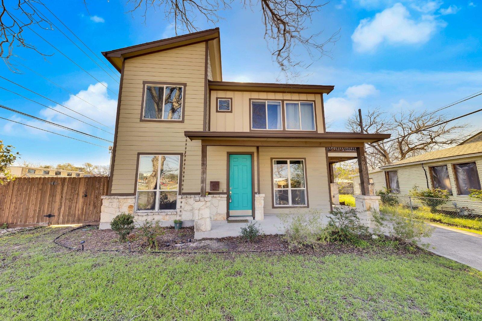 2947 Moss Street Austin, TX 78722 - Photo 1 of 20 Contemporary facade featuring a prominent teal entry door and stone detailing