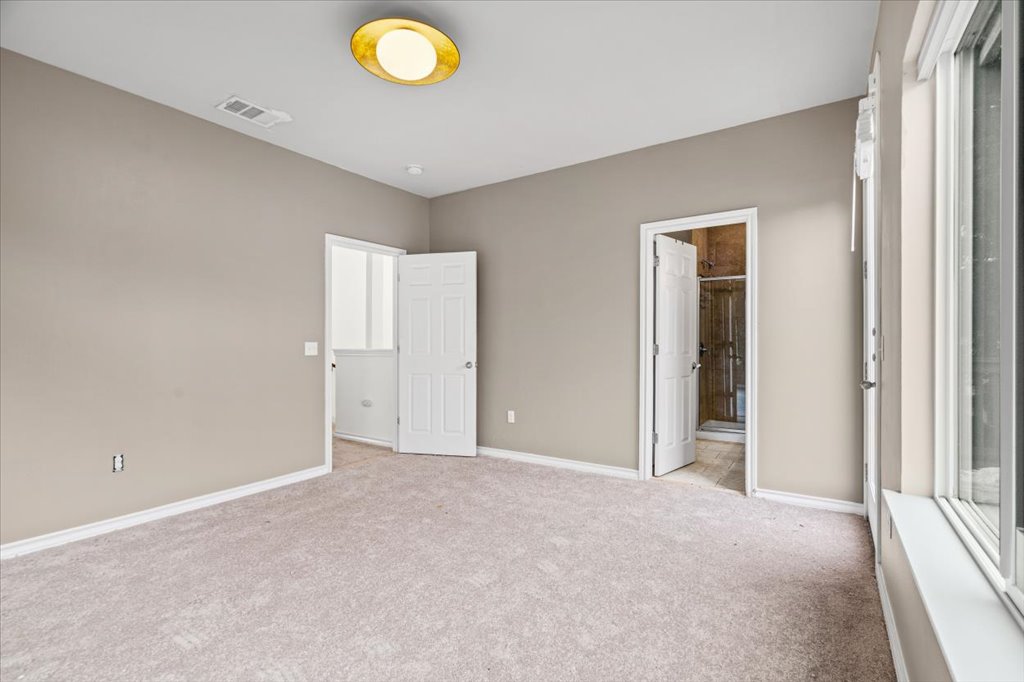 2947 Moss Street Austin, TX 78722 - Photo 11 of 20 Carpeted room with a vaulted ceiling, neutral wall paint, and white baseboards
