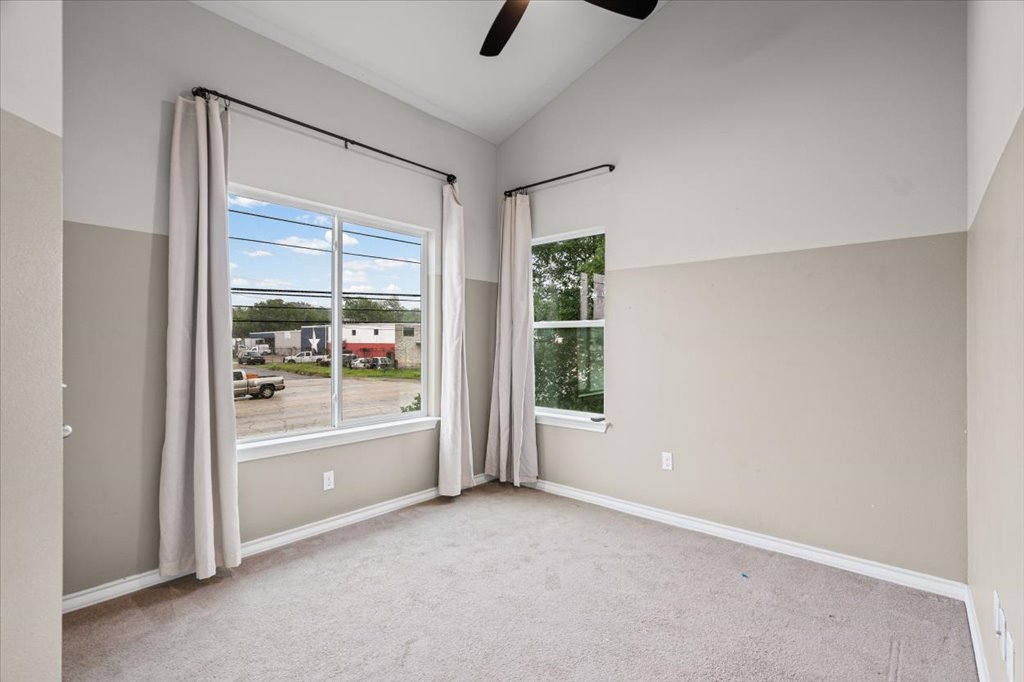 2947 Moss Street Austin, TX 78722 - Photo 13 of 20 Carpeted room featuring a vaulted ceiling and a ceiling fan