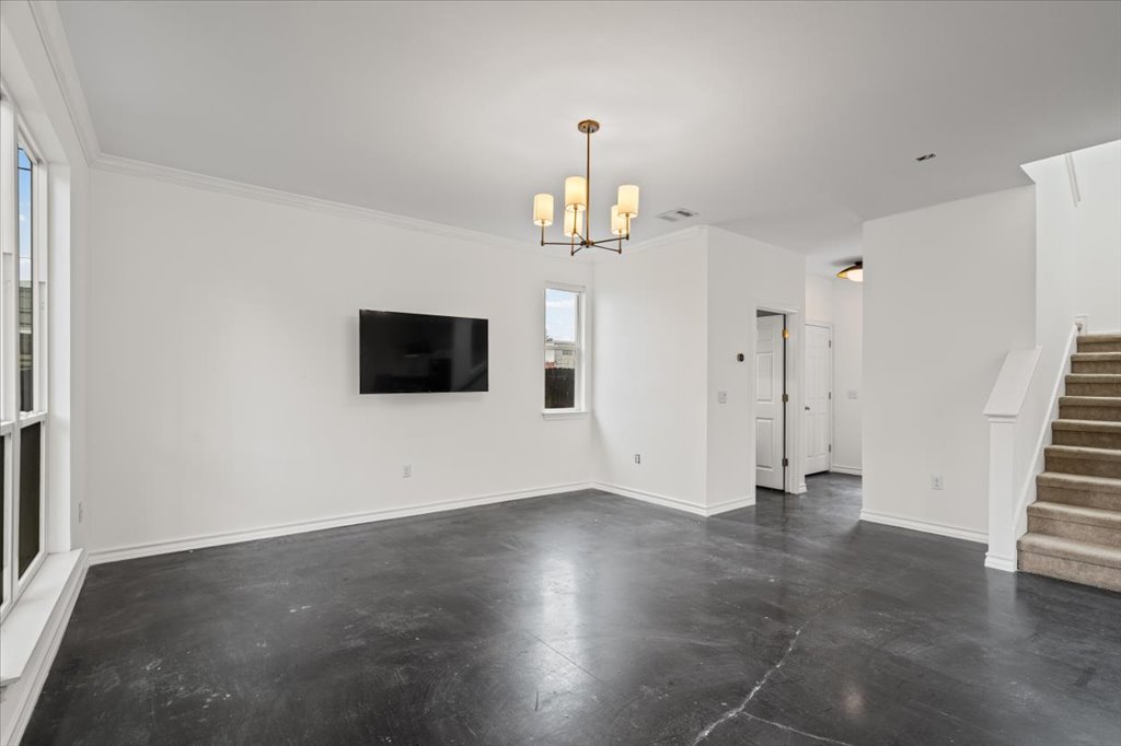 2947 Moss Street Austin, TX 78722 - Photo 3 of 20 Spacious living area featuring polished concrete flooring and white baseboards