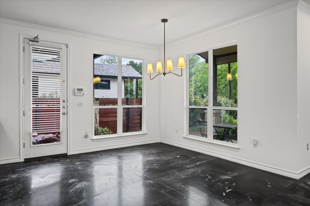 2947 Moss Street Austin, TX 78722 - Photo 5 of 20 Polished concrete flooring complemented by white baseboards and crown molding
