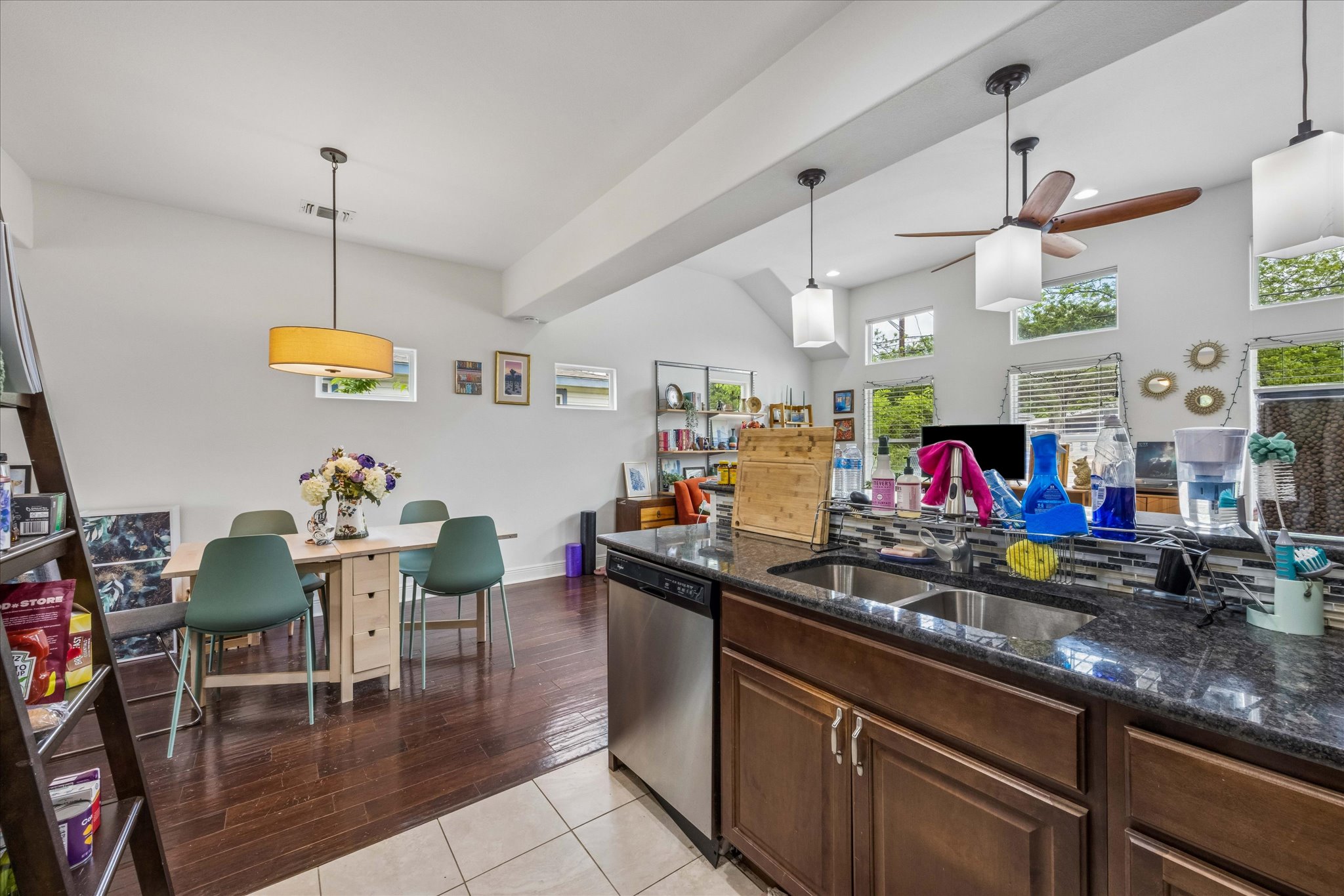 1800 Deloney Street Austin, TX 78721 - Photo 12 of 25 a kitchen with stainless steel appliances granite countertop a sink dishwasher a dining table and chairs with wooden floor