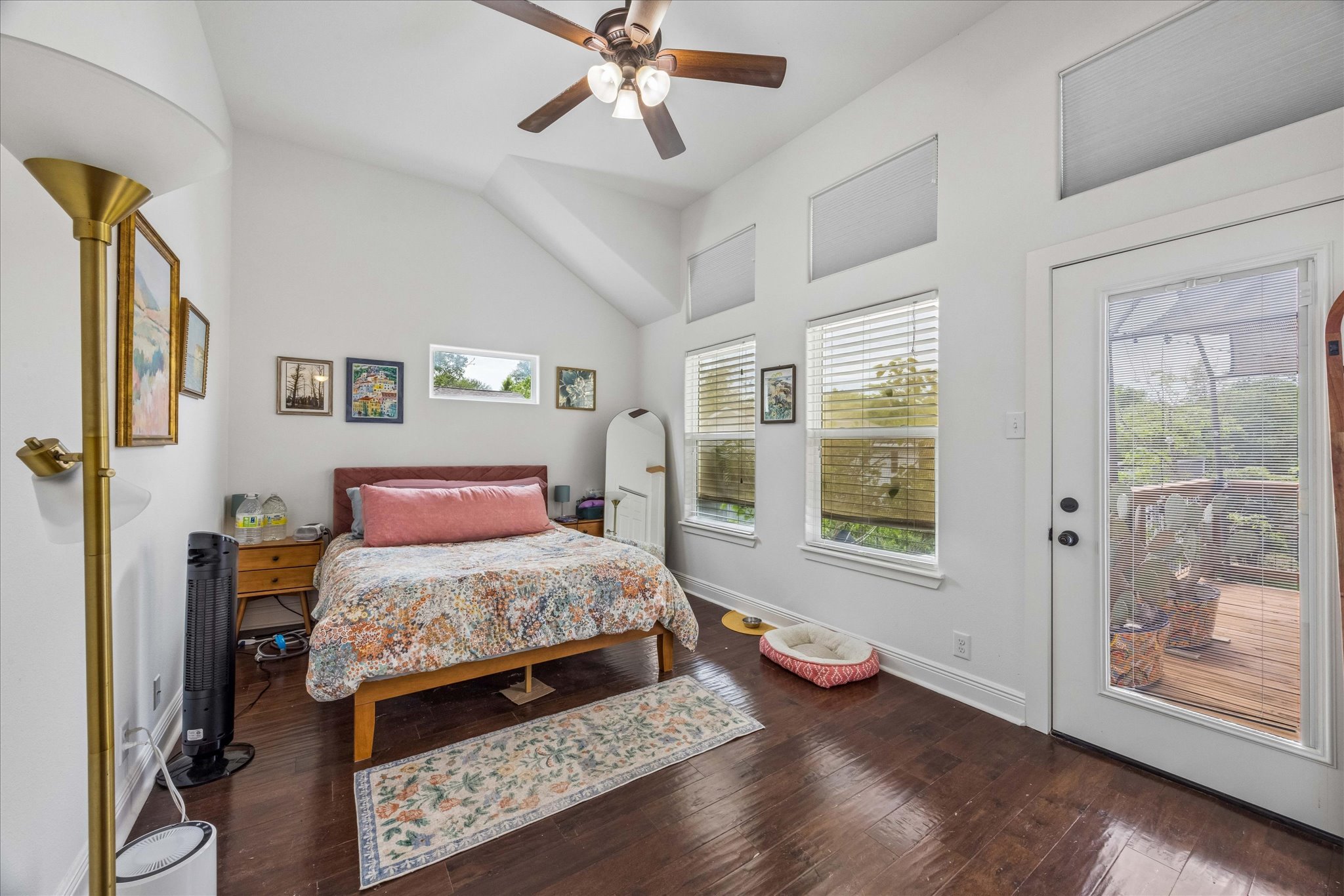 1800 Deloney Street Austin, TX 78721 - Photo 13 of 25 a bedroom with a bed and glass walk in closet