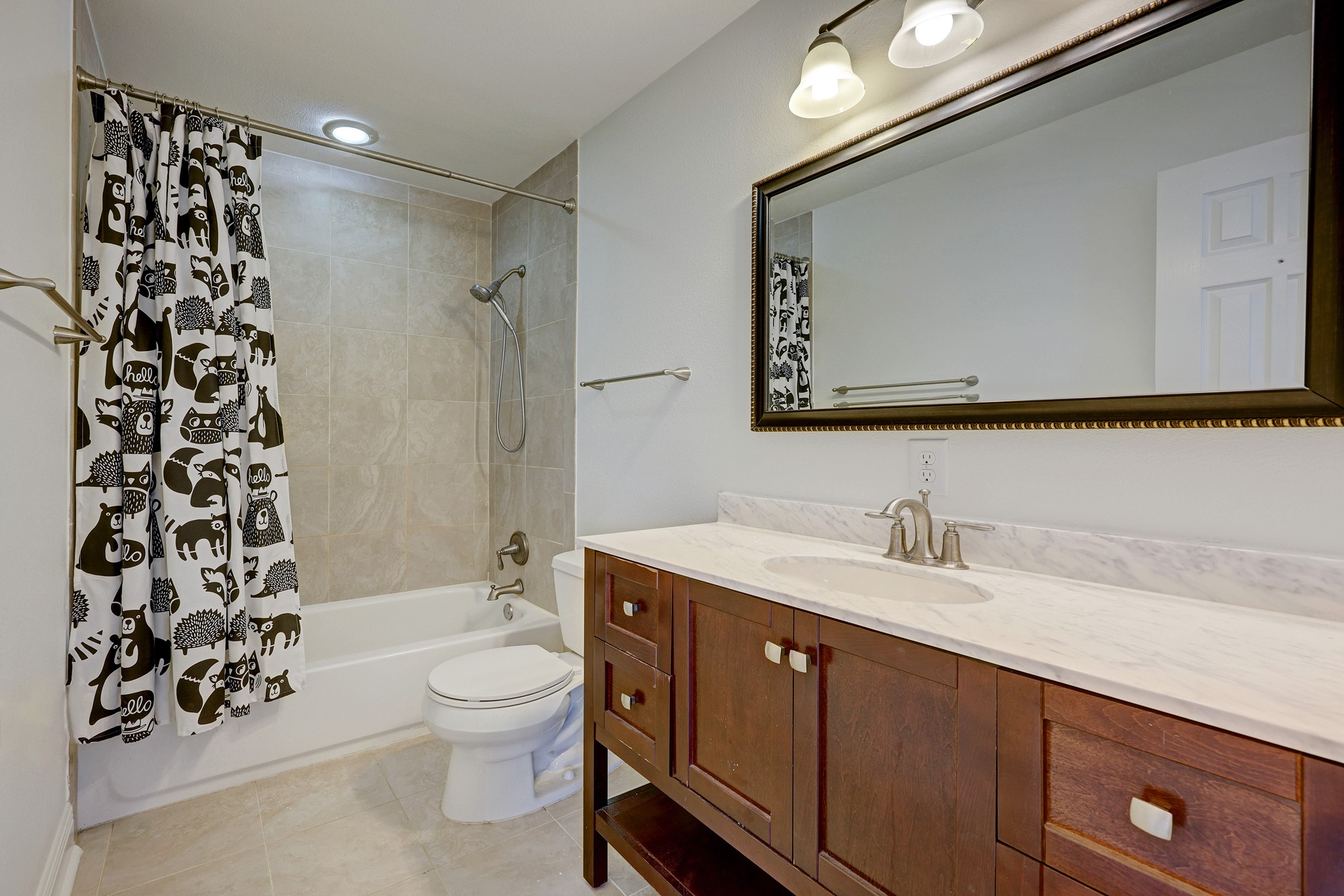 1800 Deloney Street Austin, TX 78721 - Photo 14 of 25 a bathroom with a granite countertop sink toilet a large mirror a shower and a bathtub